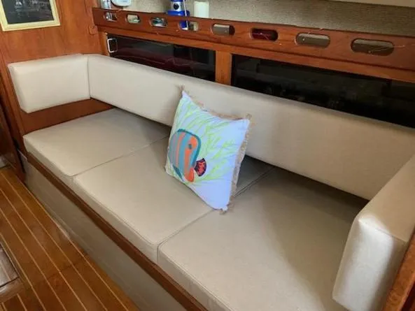 Slide: The Image of Interior of 1986 O'Day 35 sailboat with beige seating and decorative fish pillow. - 10