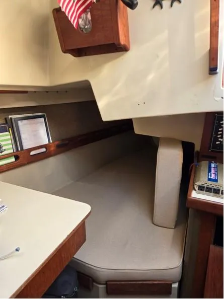 Slide: The Image of Interior cabin of a 1986 O'Day 35 sailboat with cozy seating and nautical decor. - 14