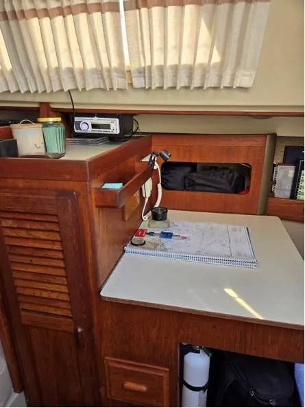 Slide: The Image of 1986 O'Day 35 sailboat interior with navigation table and storage. - 15