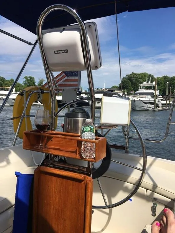 Slide: The Image of 1986 O'Day 35 sailboat cockpit with navigation equipment, beverage holder, and marina view. - 3