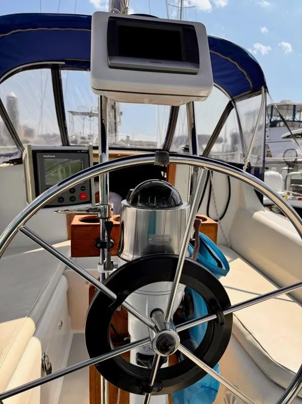 Slide: The Image of 1986 O'Day 35 sailboat cockpit with steering wheel and navigation equipment. - 4