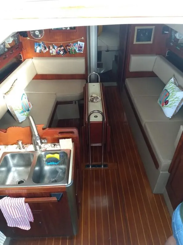 Slide: The Image of Interior of a 1986 O'Day 35 sailboat with wood flooring and cozy seating. - 8