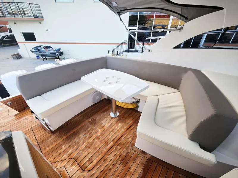 Slide: The Image of 2024 Sessa Marine C36 OB yacht with elegant seating and wooden deck. - 11