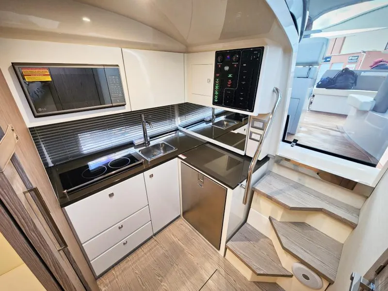 Slide: The Image of Modern kitchen interior of 2024 Sessa Marine C36 OB yacht, featuring sleek appliances and cabinetry. - 16