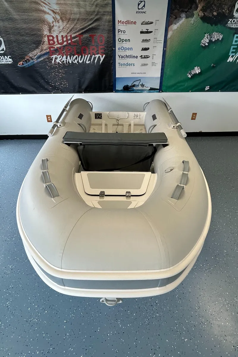 Slide: The Image of 2024 Zodiac Nomad RIB ALU 3.6 PVC inflatable boat displayed indoors. - 4