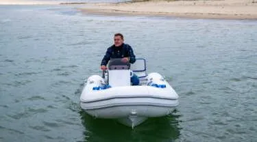 Slide: The Image of 2024 Zodiac Nomad RIB ALU 3.6 PVC boat on water with driver - 6