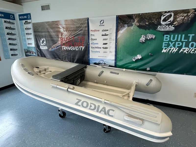 Slide: The Image of 2024 Zodiac Nomad RIB ALU 3.6 PVC inflatable boat on display in showroom. - 2