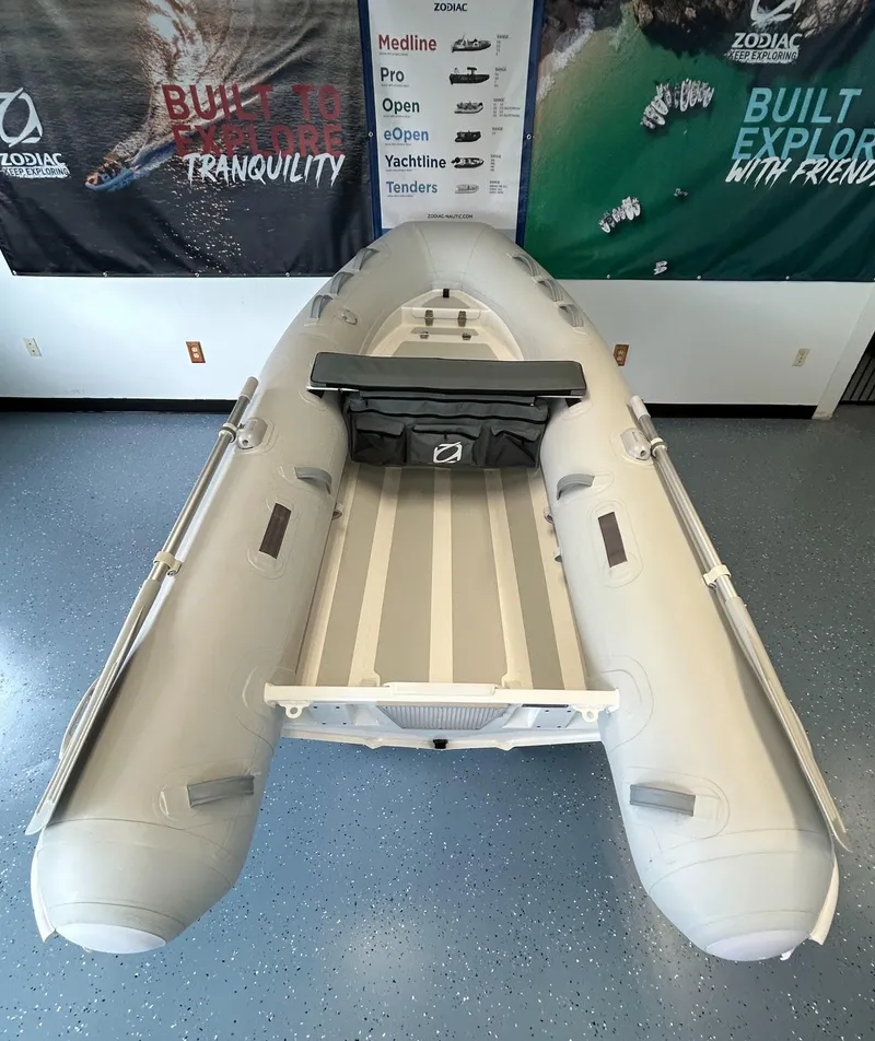 Slide: The Image of 2024 Zodiac Nomad RIB ALU 3.6 PVC inflatable boat in showroom. - 3
