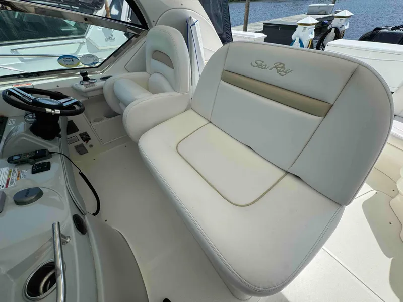 Slide: The Image of 2010 Sea Ray 390 Sundancer cockpit seating and helm station. - 11