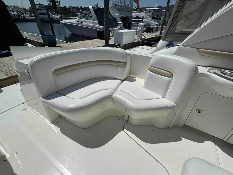 Slide: The Image of White leather seating on a 2010 Sea Ray 390 Sundancer yacht at a marina. - 12