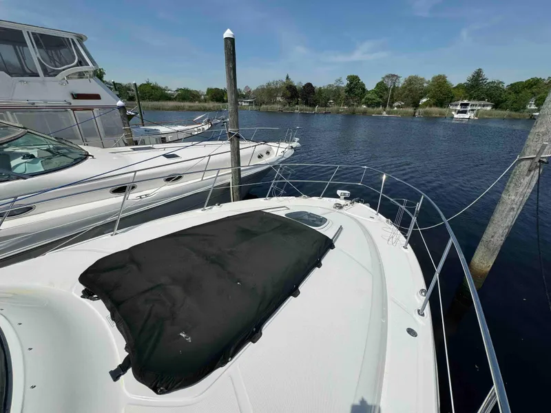 Slide: The Image of 2010 Sea Ray 390 Sundancer docked at a marina on a sunny day. - 14