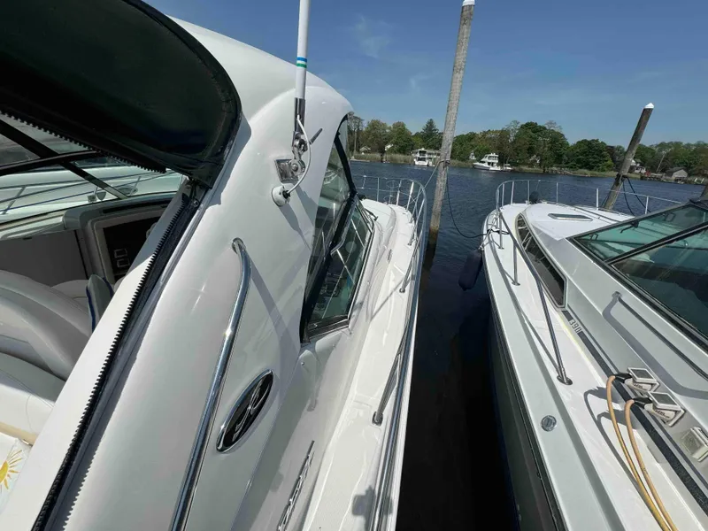 Slide: The Image of 2010 Sea Ray 390 Sundancer docked beside another boat on a sunny day. - 18