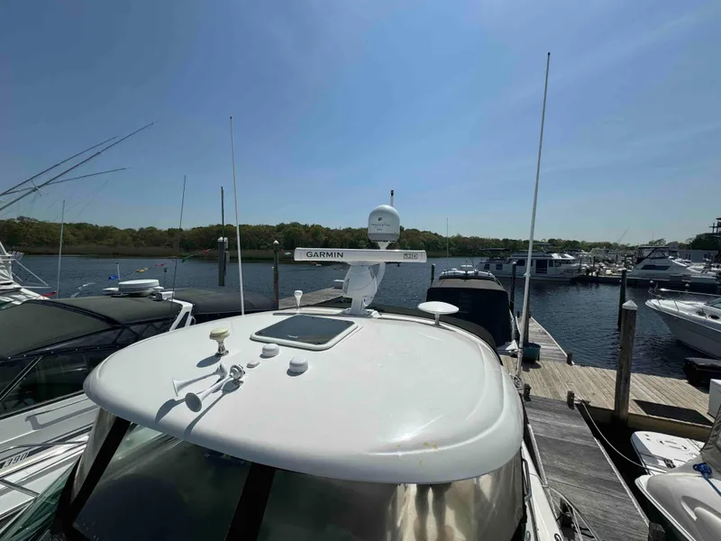 Slide: The Image of 2010 Sea Ray 390 Sundancer docked at a marina on a sunny day. - 19