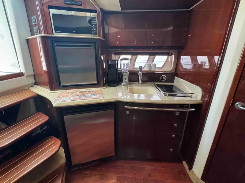 Slide: The Image of Luxurious kitchen area in a 2010 Sea Ray 390 Sundancer yacht with modern appliances. - 22