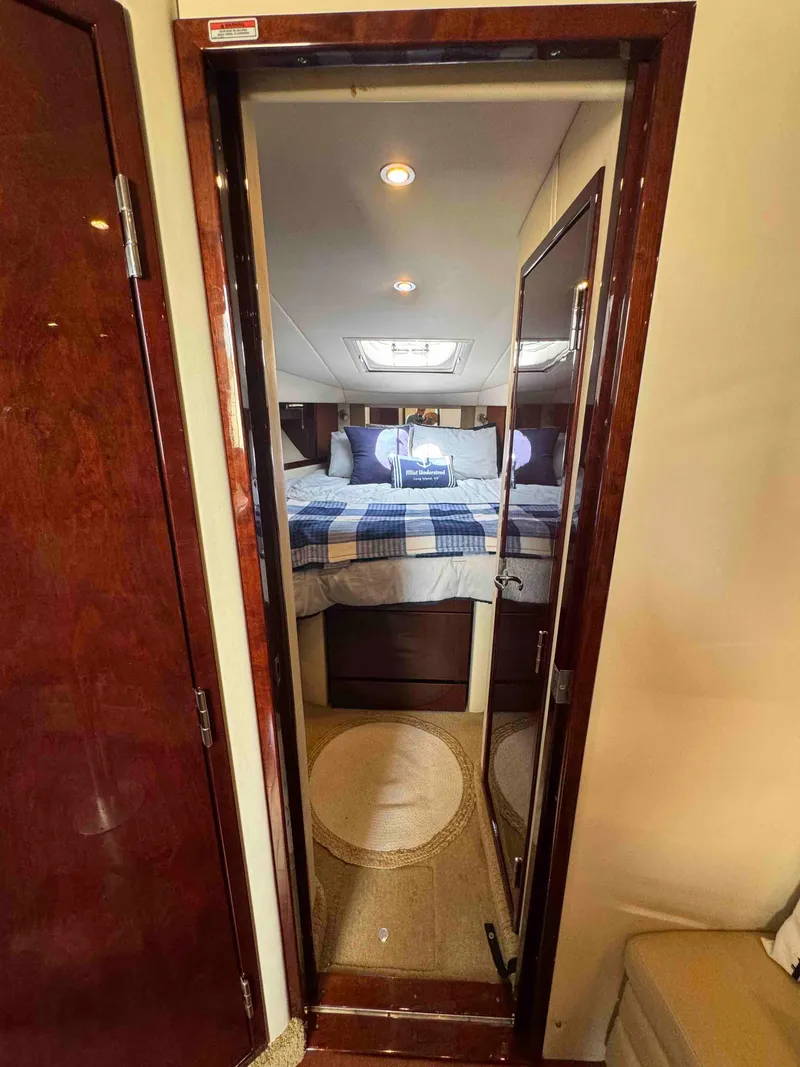 Slide: The Image of Interior cabin view of 2010 Sea Ray 390 Sundancer yacht with cozy bed and modern lighting. - 24