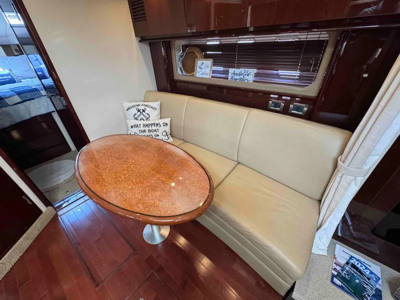 Slide: The Image of Interior of 2010 Sea Ray 390 Sundancer with beige sofa and oval table. - 28