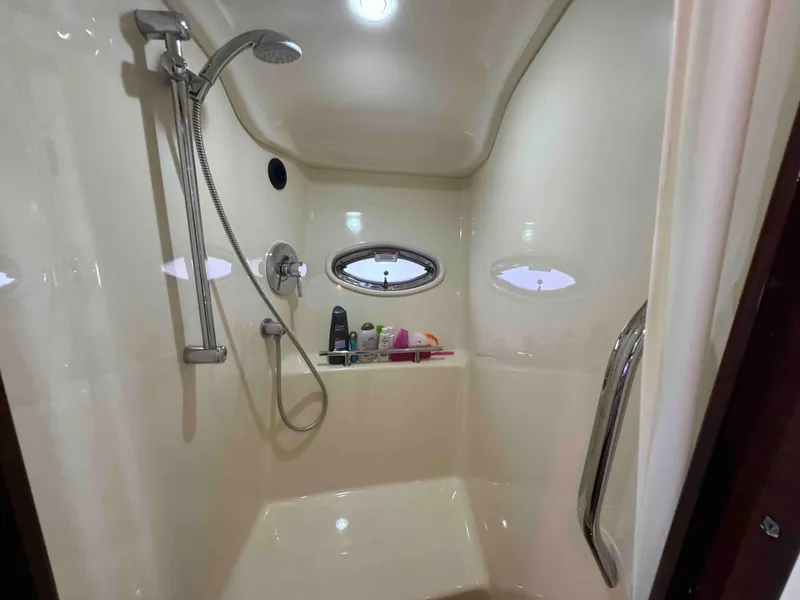 Slide: The Image of 2010 Sea Ray 390 Sundancer shower with modern fixtures and porthole windows. - 29
