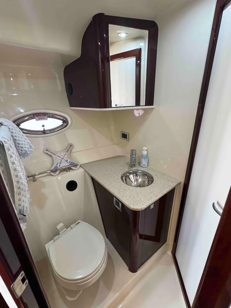 Slide: The Image of Modern bathroom in 2010 Sea Ray 390 Sundancer yacht with sink, toilet, and storage. - 30