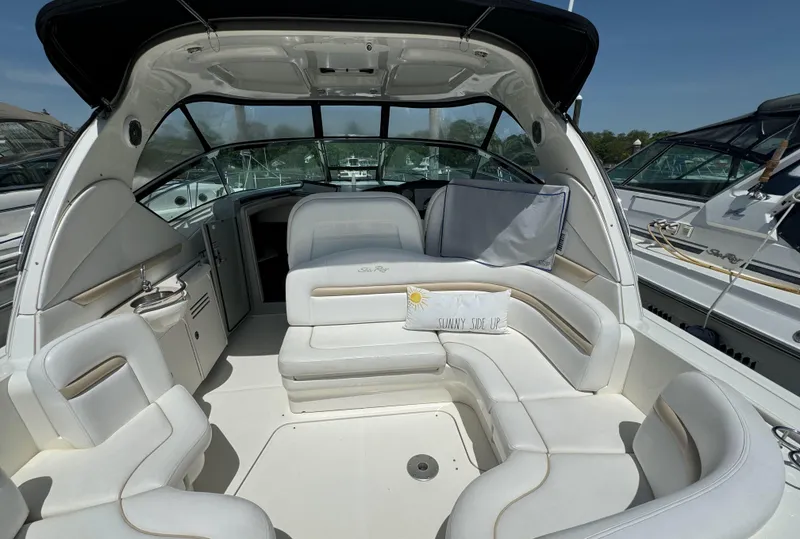 Slide: The Image of 2010 Sea Ray 390 Sundancer boat interior with white leather seating and spacious layout. - 4