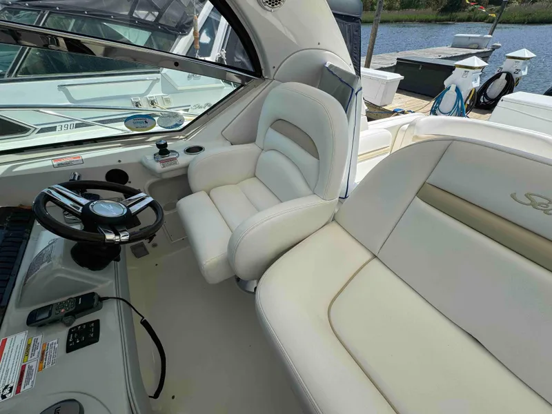 Slide: The Image of Sea Ray 390 Sundancer 2010 helm station with white leather seats and steering wheel. - 6