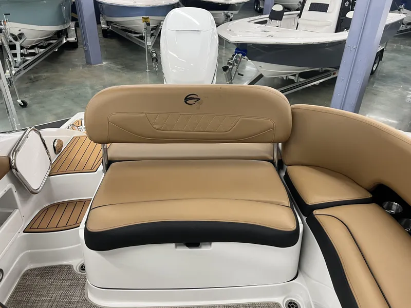 Slide: The Image of 2024 Crownline 270 XSS boat interior with tan leather seating and wood accents. - 11