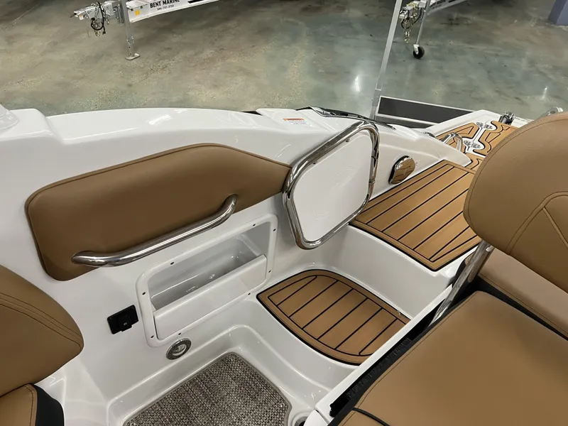 Slide: The Image of 2024 Crownline 270 XSS boat interior with tan seating and teak-style flooring. - 12