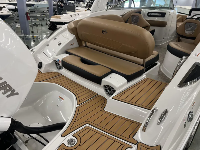 Slide: The Image of 2024 Crownline 270 XSS boat interior with tan seating and teak flooring. - 13