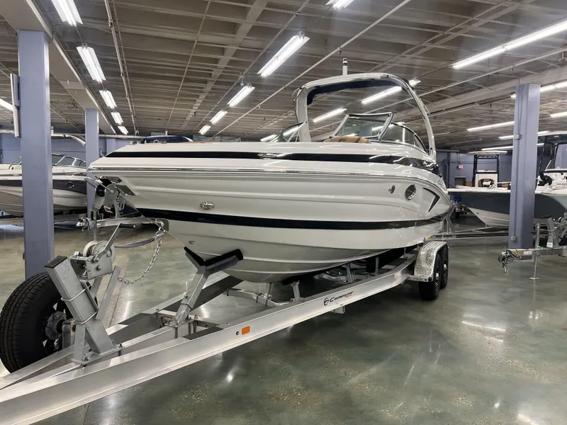 Slide: The Image of 2024 Crownline 270 XSS boat on a trailer in a showroom. - 5