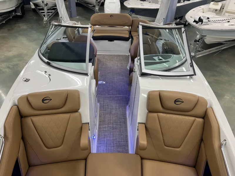 Slide: The Image of 2024 Crownline 270 XSS boat interior with tan leather seats and open windshield. - 7