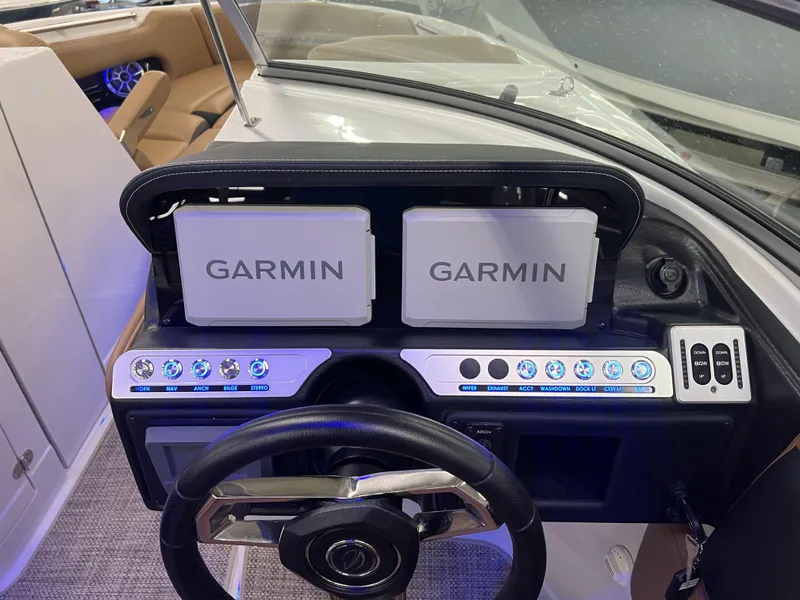 Slide: The Image of 2024 Crownline 270 XSS dashboard with dual Garmin displays and illuminated control panel. - 8
