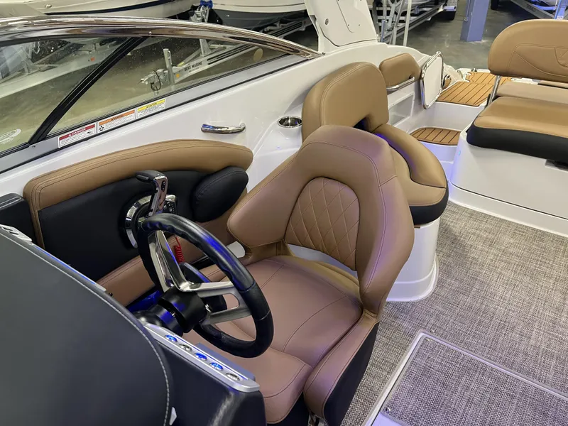 Slide: The Image of 2024 Crownline 270 XSS boat interior with tan leather seats and modern steering wheel. - 9