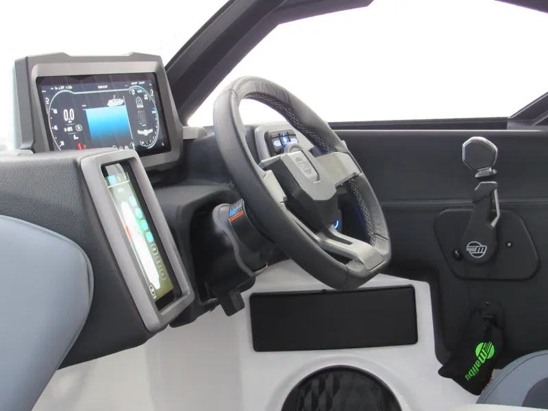 Slide: The Image of 2024 Malibu Wakesetter 23 MXZ dashboard with steering wheel and digital displays. - 10