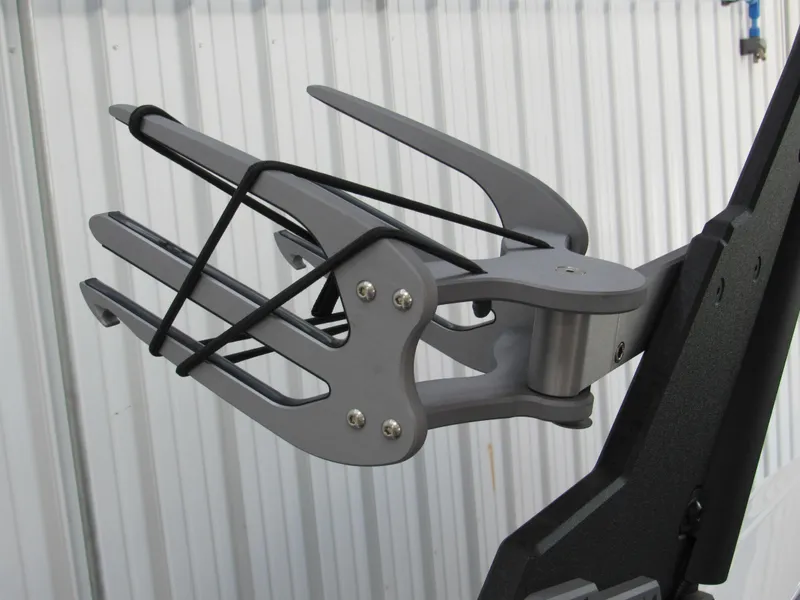 Slide: The Image of 2024 Malibu Wakesetter 23 MXZ wakeboard rack, mounted on a boat, against a metal wall. - 19