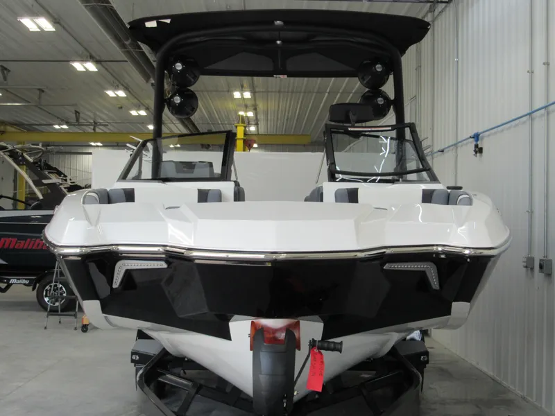 Slide: The Image of 2024 Malibu Wakesetter 23 MXZ boat in a showroom, front view. - 2