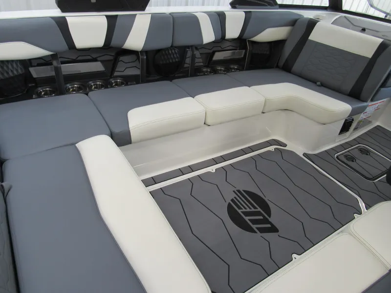 Slide: The Image of 2024 Malibu Wakesetter 23 MXZ interior seating, featuring sleek gray and white upholstery. - 7