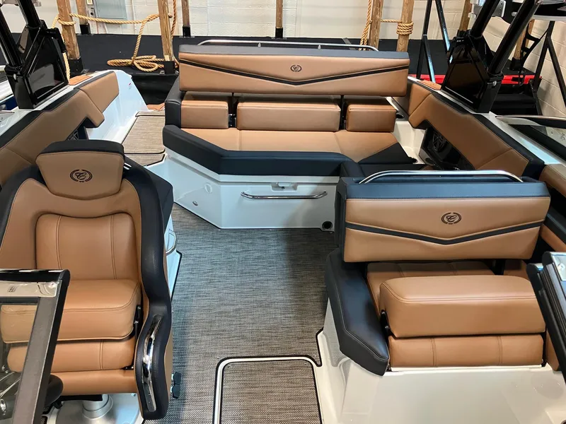 Slide: The Image of 2024 Cobalt R4 Surf boat interior with luxurious tan and black seating. - 16