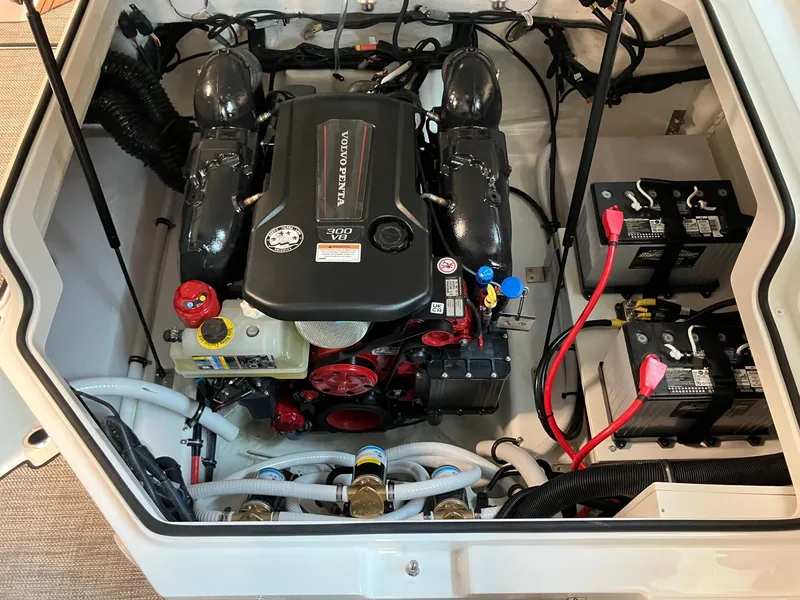 Slide: The Image of 2024 Cobalt R4 Surf engine compartment with Volvo Penta engine and dual batteries. - 18