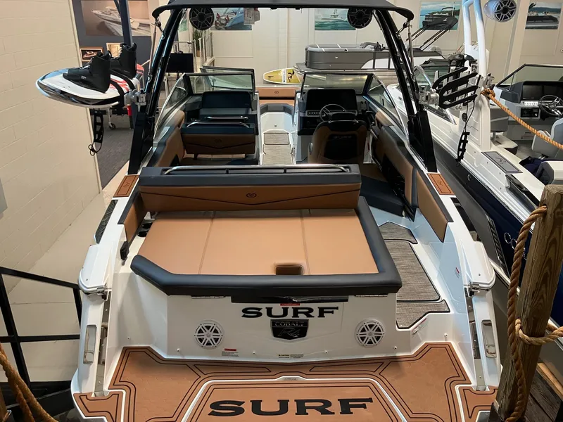 Slide: The Image of 2024 Cobalt R4 Surf boat interior with tan seating and surfboard rack. - 4