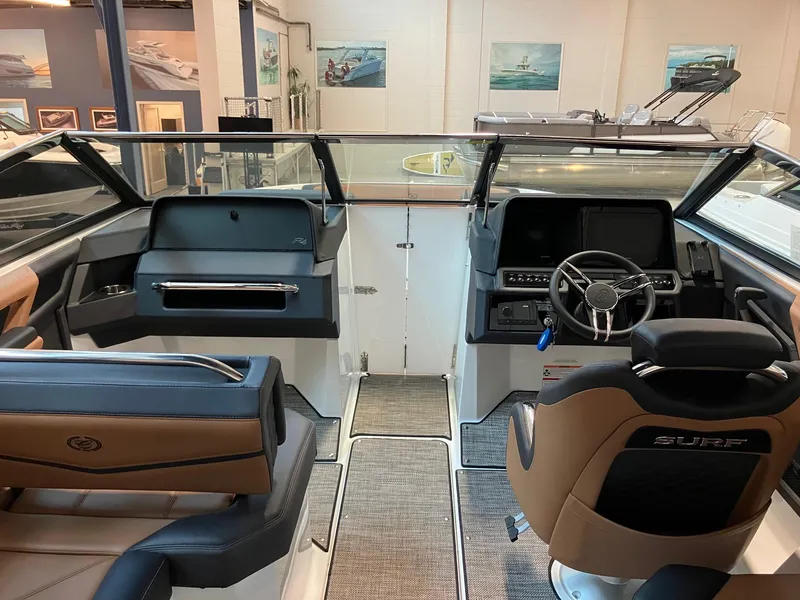 Slide: The Image of Interior of 2024 Cobalt R4 Surf boat with modern dashboard and seating. - 8