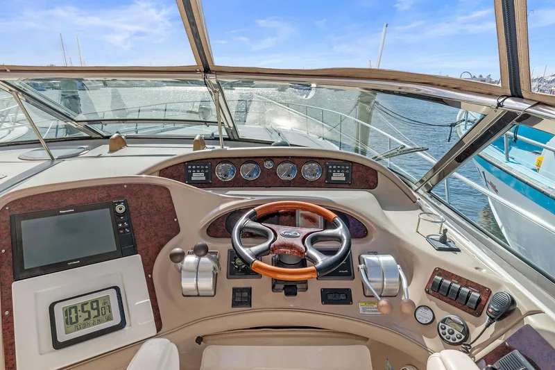 Slide: The Image of Helm of 2002 Sea Ray 550 Sundancer with steering wheel, gauges, and navigation equipment. - 11