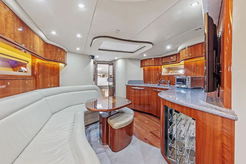 Slide: The Image of Luxurious interior of 2002 Sea Ray 550 Sundancer yacht with modern kitchen and seating area. - 13