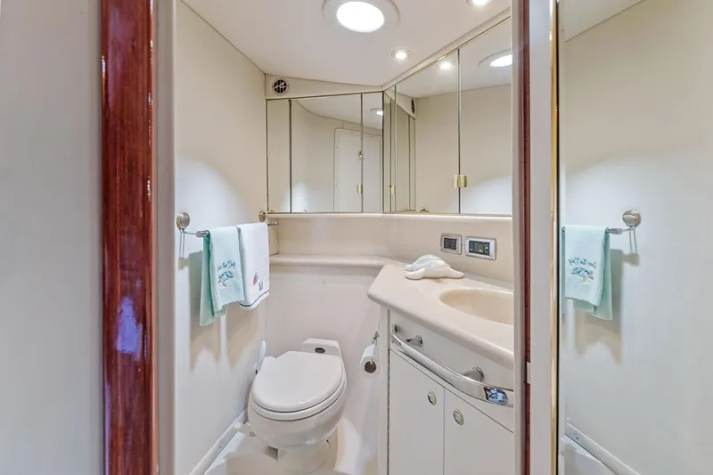 Slide: The Image of 2002 Sea Ray 550 Sundancer yacht bathroom with modern fixtures and ample storage. - 17