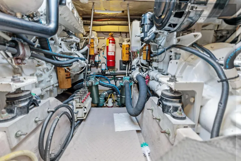 Slide: The Image of Engine room of a 2002 Sea Ray 550 Sundancer yacht with visible machinery and equipment. - 26