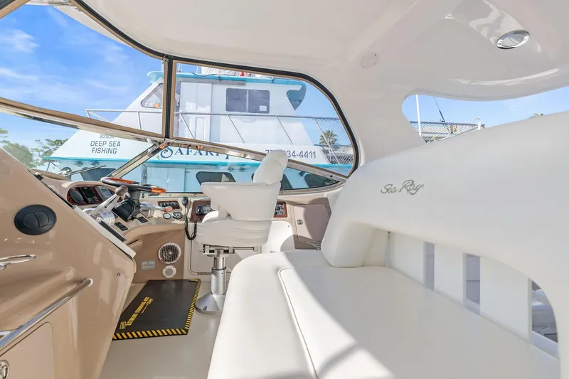 Slide: The Image of Interior of 2002 Sea Ray 550 Sundancer yacht with helm and seating area. - 9