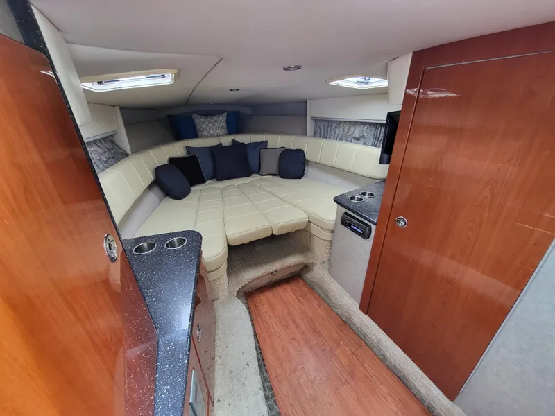 Slide: The Image of 2007 Formula 330 SS cabin with beige seating and wooden accents. - 38
