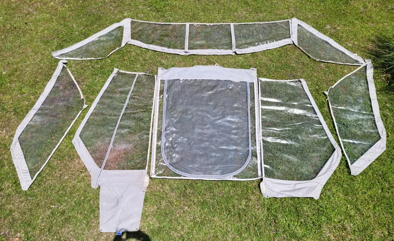 Slide: The Image of 2007 Formula 330 SS boat canvas enclosure set laid out on grass. - 49