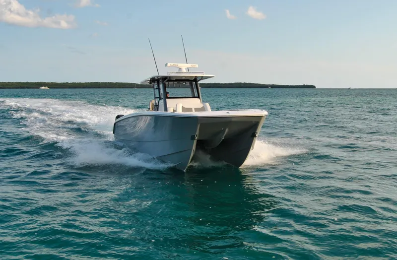 Slide: The Image of 2020 Invincible 40 Catamaran cruising on open water. - 12