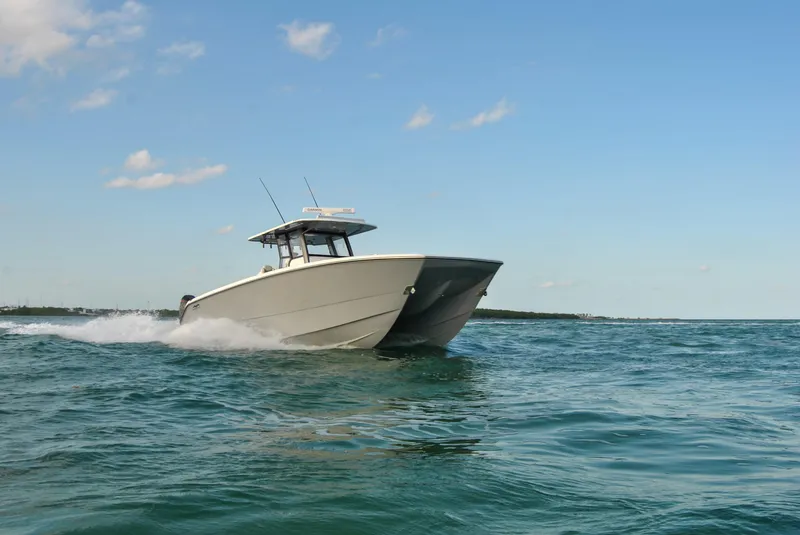 Slide: The Image of 2020 Invincible 40 Catamaran cruising on open water. - 15