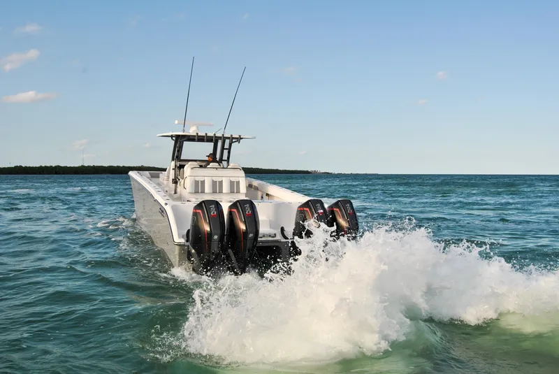 Slide: The Image of 2020 Invincible 40 Catamaran cruising on open water with four outboard engines. - 17