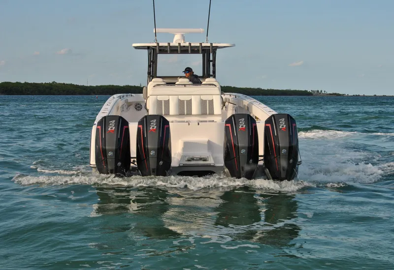 Slide: The Image of 2020 Invincible 40 Catamaran with quad outboard engines cruising on the water. - 18